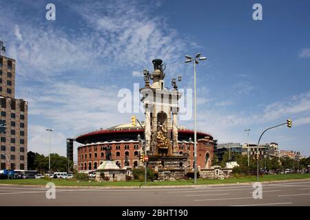 View of famous square called 'Placa d'Espanya' in Barcelona. Big shopping mall 'Arenas de Barcelona' are in the view. It is a sunny summer day. Stock Photo