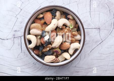 Mixed nuts in wooden bowls on wooden table . Stock Photo