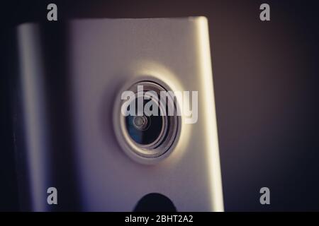 Black minimalist CCTV camera at home on a wooden table. Stock Photo