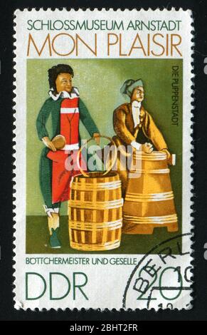 GERMANY  - CIRCA 1974: FScenes from 18th century Thurigia, Dolls Village, Arnstadt Castle Museum. Cooper and apprentice,  circa 1974. Stock Photo