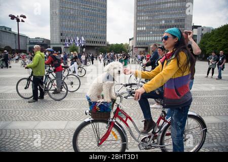 Ljubljana, Slovenia. 27th Apr, 2020. A woman with her dog seated in a bicycle basket takes part during the demonstration.Around five hundred people protested in front of Slovenian parliament building against the government and its alleged corruption amid the coronavirus measures and restrictions. Credit: SOPA Images Limited/Alamy Live News Stock Photo