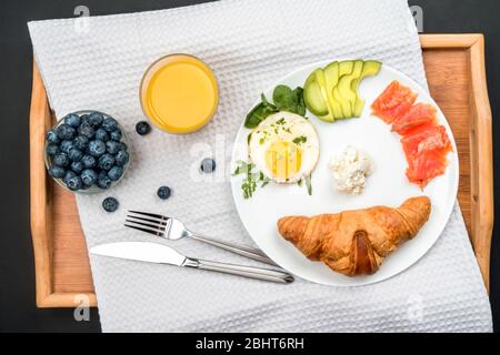 European Breakfast with croissants and fish on a wooden tray Stock Photo