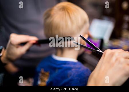 A little boy in the Barber shop at the hairdresser's. Stock Photo