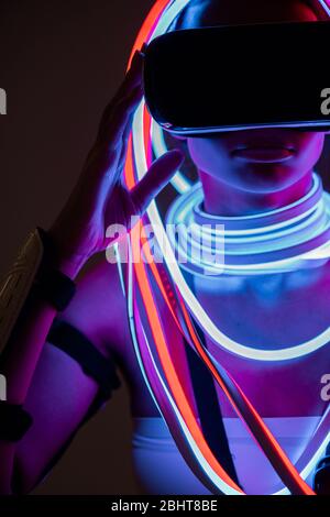 futuristic african american woman in vr headset and neon lighting Stock Photo