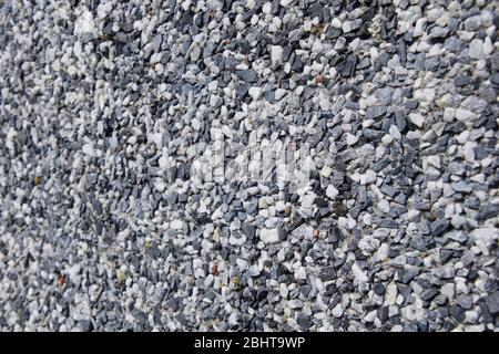 Wall covered in small blue and white rocks. Stock Photo