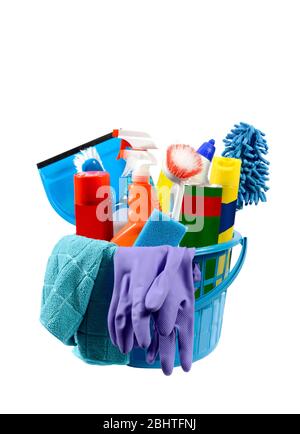 Vertical shot of a round blue plastic basket filled with cleaning supplies isolated on white. Stock Photo