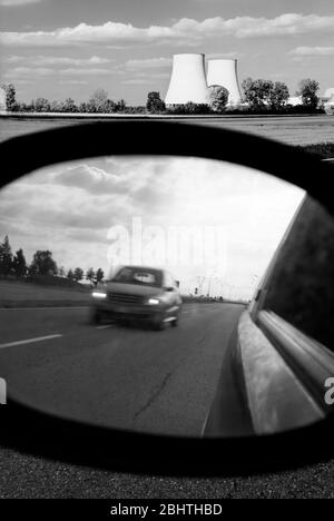 Cooling towers viewed from the mirror of a car Stock Photo