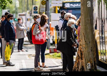 Berlin, Germany. 27th Apr, 2020. Passengers wearing face masks wait for bus at a bus station in Berlin, capital of Germany, April 27, 2020. In most German states, face masks or an equivalent mouth-and-nose cover have become mandatory on Monday when people travel by bus or train or go for shopping. The rate of new COVID-19 infections in Germany continued below peak times as the number of confirmed cases increased by 1,018 within one day to 155,193, the Robert Koch Institute (RKI) announced on Monday. Credit: Binh Truong/Xinhua/Alamy Live News Stock Photo