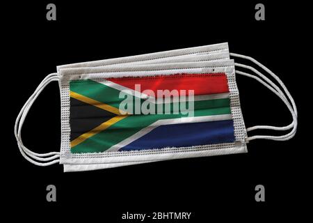 Surgical face masks with South Africa flag printed. Isolated on black background. Concept of face mask usage in South African effort to combat Covid-1 Stock Photo