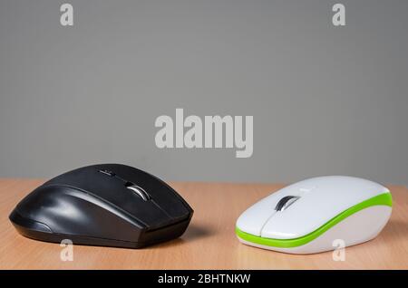Close view of two wireless- bluetooth  pc mouse devices   on wooden  background. Stock Photo