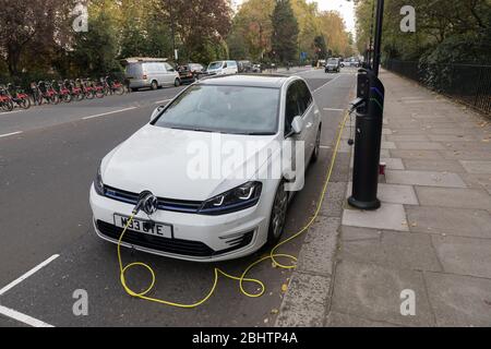Electric car charging in street, London, England, UK Stock Photo