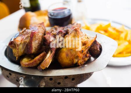 Popular Argentinian dish asado of grilled meats served at dinner Stock Photo