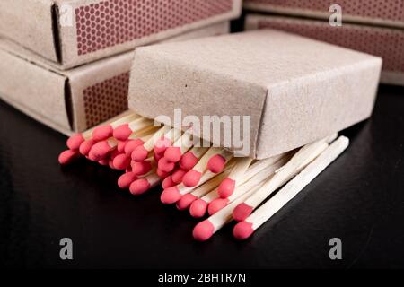 Matches for resurrecting fire in gray boxes. Old methods of lighting a fire. Dark background. Stock Photo