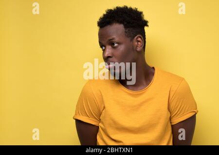 Young african american man looking down with guilty confused expression Stock Photo