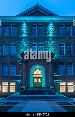 Calgary, Alberta - April 26, 2020: View of the facade of cSpace in Calgary at night. cSpace is a arts incubator and hub that was converted from a hist Stock Photo