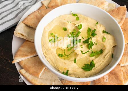 Baba Ganoush with Pita Bread: Eggplant dip made with garlic and tahini drizzled with olive oil and garnished with chopped parsley Stock Photo