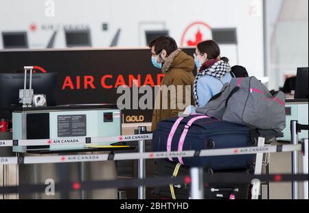 Toronto, Canada. 27th Apr, 2020. Travellers check in at the Air Canada counters of Pearson International Airport in Toronto, Canada, April 27, 2020. Air Canada suspended all scheduled flights to the United States for four weeks starting on Monday. As of Monday afternoon, there were 48,230 confirmed COVID-19 cases in Canada and 2,701 deaths. Credit: Zou Zheng/Xinhua/Alamy Live News Stock Photo