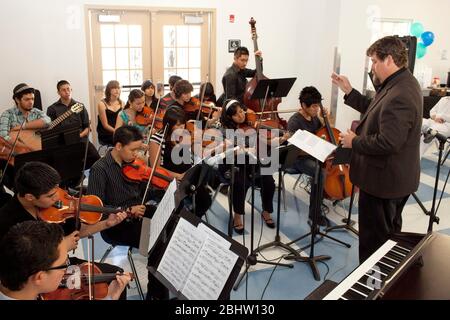 El Paso, Texas USA,  May 2010: Students reading sheet music play stringed instruments in music rehearsal classroom at Mission Early College High School. ©Bob Daemmrich Stock Photo