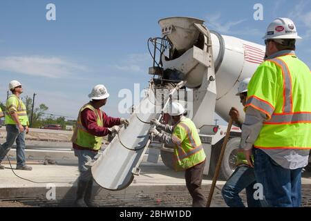 Austin Texas USA, April 6, 2011:Workers pour concrete onto roadway during highway construction project. ©Marjorie Kamys Cotera/Daemmrich Photography Stock Photo