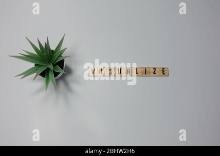 The word Visualization is written in wooden letter tiles on a white background. Stock Photo