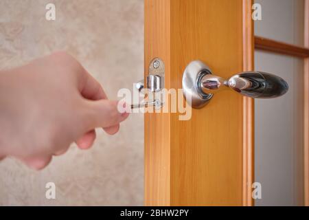 The concept of repairing a door and a lock in a house. Close up. Stock Photo
