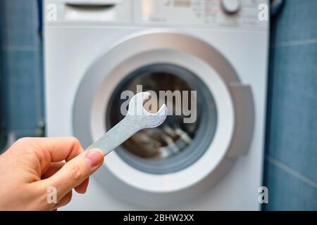 The concept of repairing a washing machine in the bathroom. Close up. Stock Photo