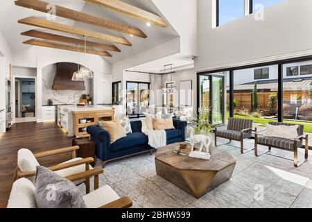 Kitchen and living room interior in new luxury home with open concept floor plan. Stock Photo