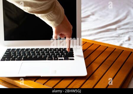 Hand pressing a key on the computer. Concept of typing on the computer. Stock Photo