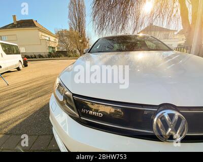 Paris, France- Feb 6, 2020: Front view of logotype on the new Volkswagen Golf Hybrid car parked on French street Stock Photo