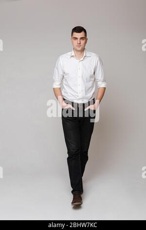 Thoughtful businessman looking at camera in studio Stock Photo
