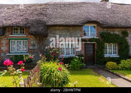 Small old white house with straw roof Stock Photo