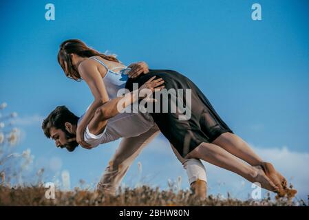 Young beautiful barefoot couple dancer practicing modern dance Stock Photo