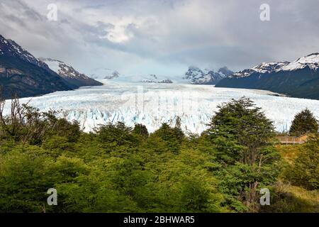 landscape with Perito Moreno glacier, andes mountains, forest and rainbow, Patagonia, Argentina Stock Photo