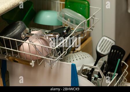 Newport News, VA/USA-March 16, 2020: A load of colorful dishes in a dishwasher waiting to be put away. Stock Photo