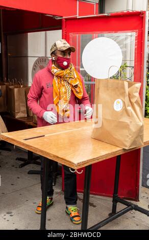 New York, NY - April 27, 2020: Renowed chef Marcus Samuelsson of Red Rooster restaurant helps distribute free food to needy people during COVID-19 pandemic in Harlem Stock Photo