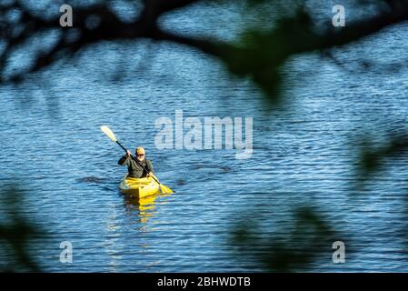 Senior kayaking on Stone Mountain Lake in Atlanta, Georgia's Stone Mountain Park. (USA) Stock Photo