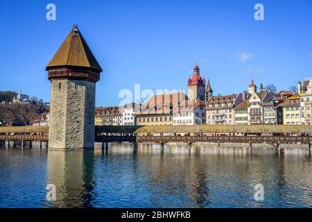 Panoramic view over the river Reuss to the Chapel Bridge and Water Tower, Old Town, Lucerne, Switzerland Stock Photo