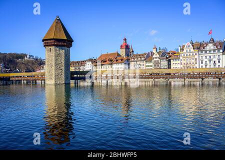 Panoramic view over the river Reuss to the Chapel Bridge and Water Tower, Old Town, Lucerne, Switzerland Stock Photo