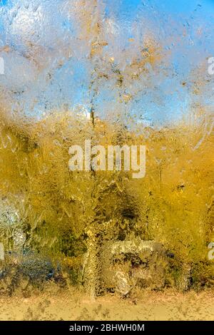 Impressionistic silhouette of reality looking through the waterfall cascade down the glass wall in the National Gallery of Victoria in Melbourne. Stock Photo
