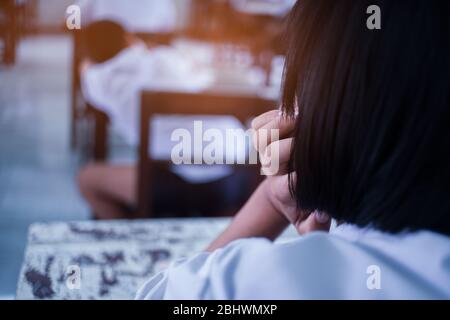 School students thinking and taking exam answer in classroom with stress Stock Photo