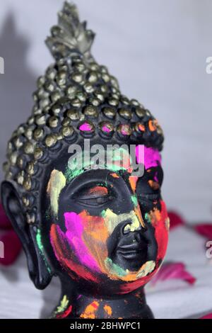 colorful face of lord Buddha statue in festival, traditional colors on face. Stock Photo