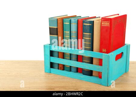 Books in wooden box isolated on white Stock Photo