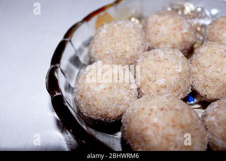 Sesame seed jaggery ball or til ke laddo and tilgul or til gul laddu served in bowl for Makar Sankranti Festival in India Stock Photo