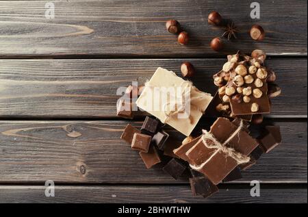 Set of chocolate with hazelnut on wooden table, top view Stock Photo