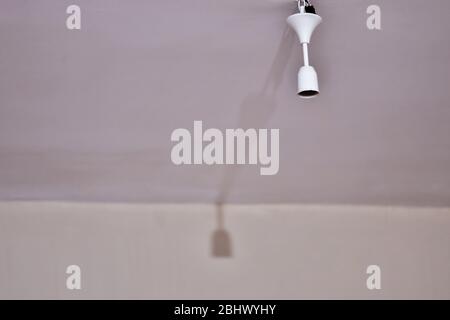 Bulb holder hanging on the ceiling. Empty is not plugged in. Stock Photo