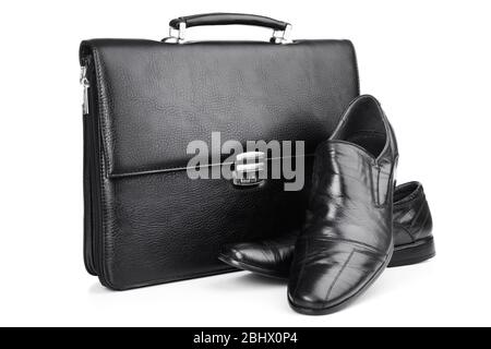 Black leather briefcase with shoes isolated on white Stock Photo
