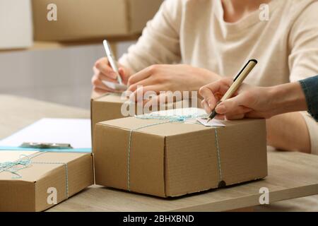 Women signs parcels in post office Stock Photo