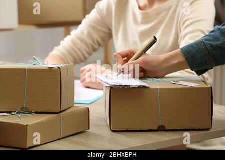 Women signs parcels in post office Stock Photo
