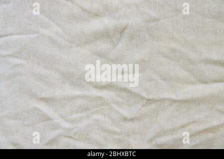 Crumpled white linen fabric cotton for wallpaper design. Brown weave cotton background texture. Stock Photo