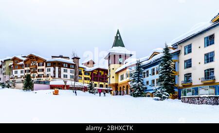 Colorful buildings and the Clock Tower in the Winter Sport Village of Sun Peaks, an Alpine Village in the Shuswap Highlands of BC, Canada Stock Photo